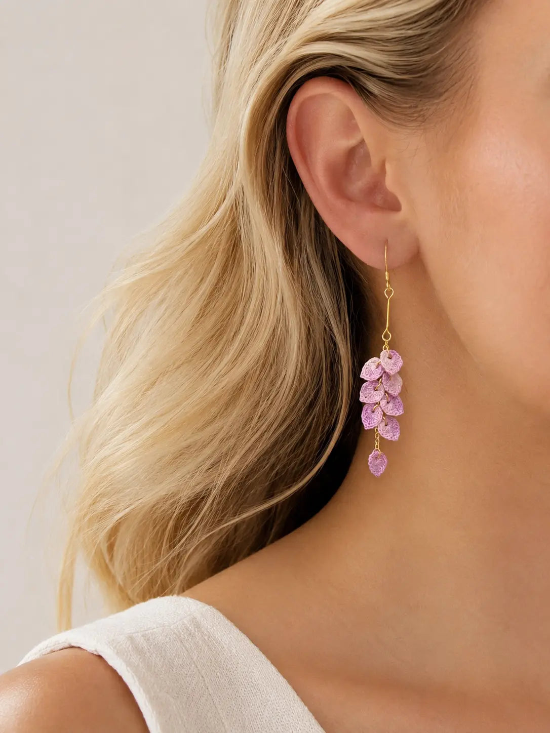 Close-up of purple micro crochet Tassel Leaves Drop Earrings worn by a blonde model