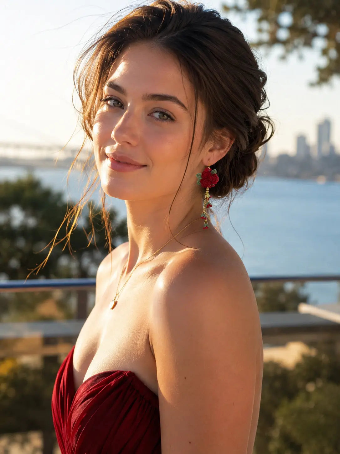 Model wearing micro crochet Rose Cluster Dangle Earrings with an elegant red dress in a warm outdoor lifestyle setting.