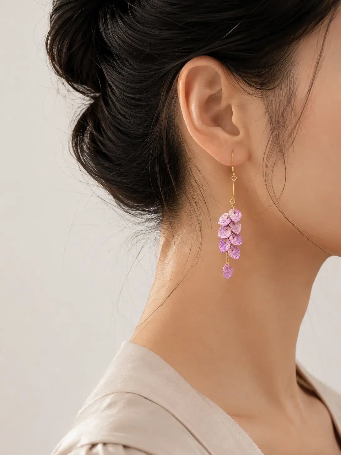 Side view of purple Tassel Leaves Drop Earrings worn by a brunette model