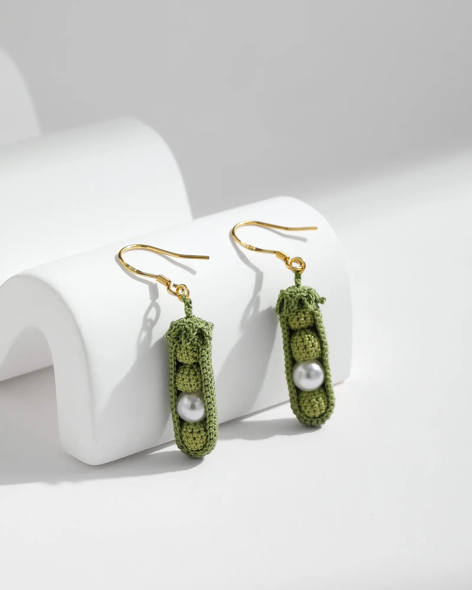 Micro crochet Pea Pod Earrings featuring green pea pod designs with pearl details and gold-tone hooks on a clean white background.