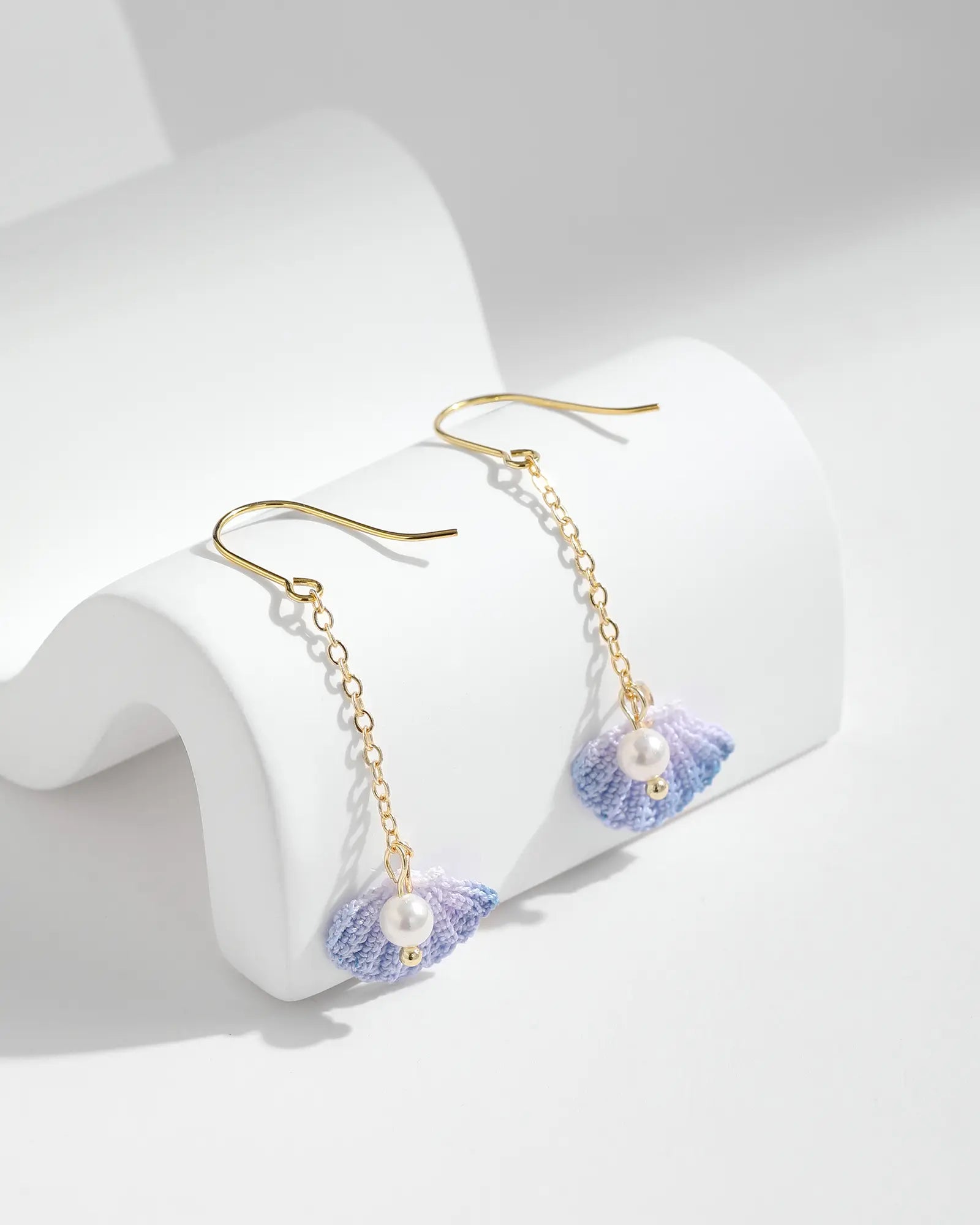 Blue Seashell & Freshwater Pearl Earrings with gold-tone hooks on a white background