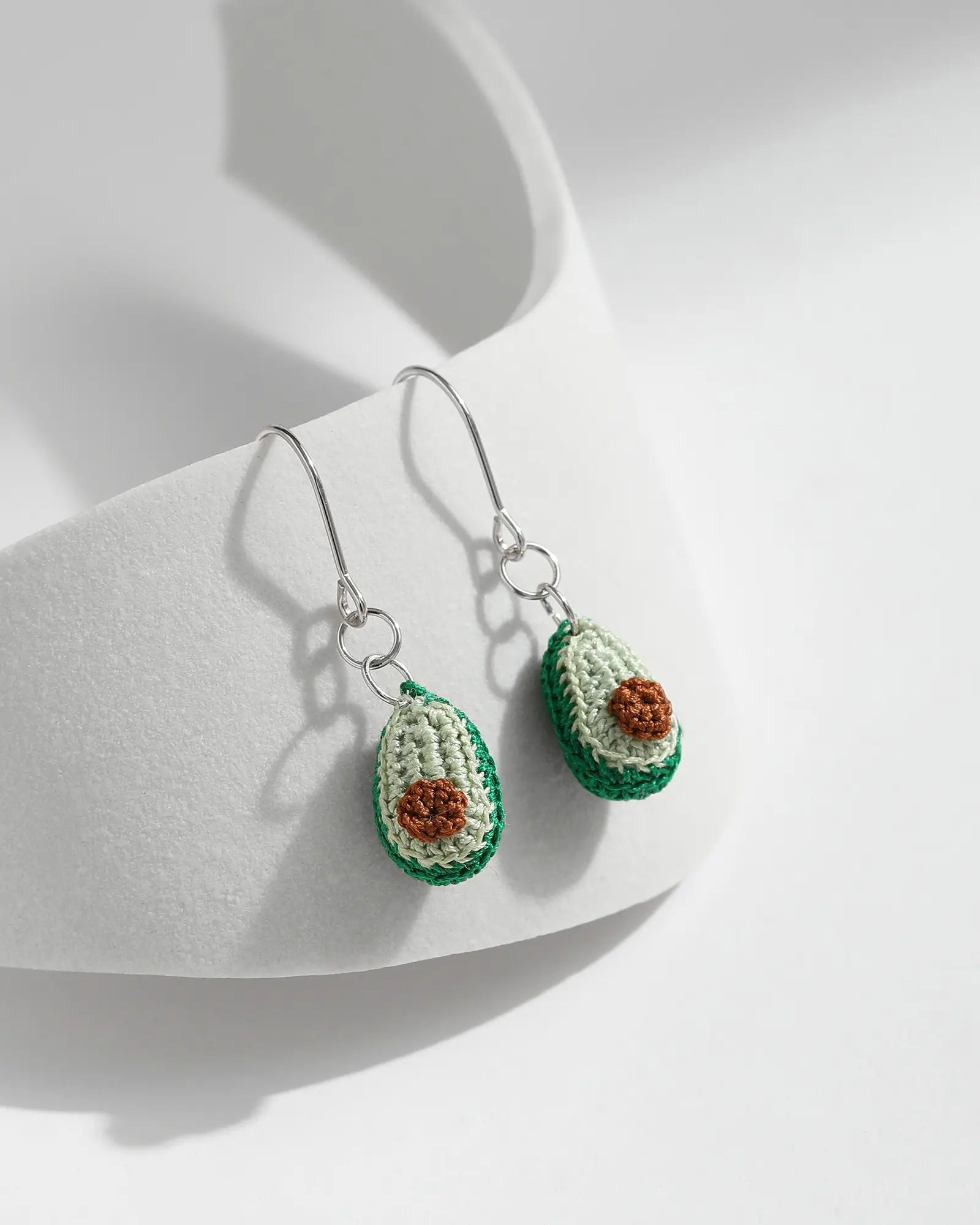 Micro crochet Avocado Drop Earrings featuring green avocado designs with brown seed details and silver hooks on a clean white background.