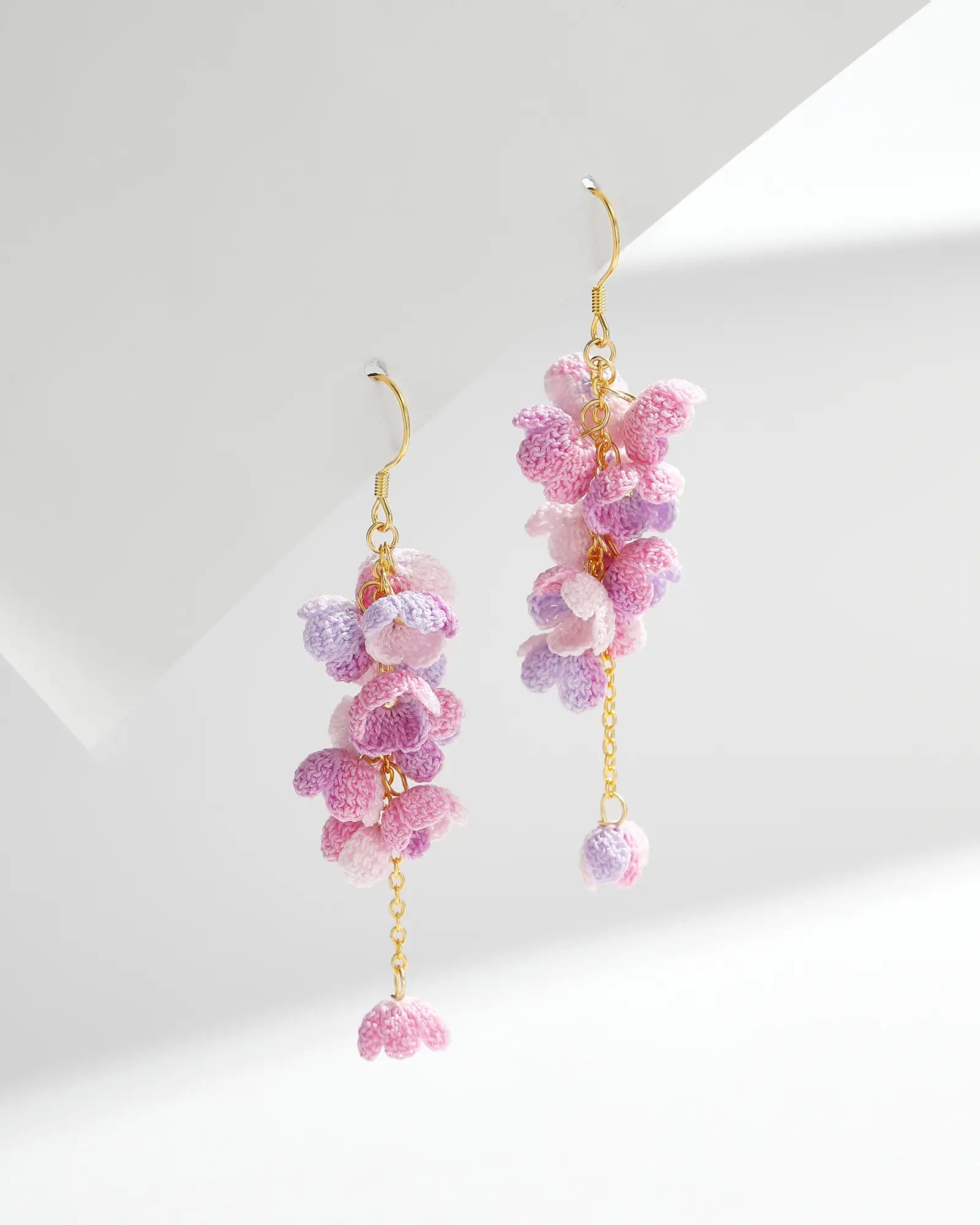 Gradient purple micro crochet Cascading Flower Drop Earrings with gold hooks on a white background