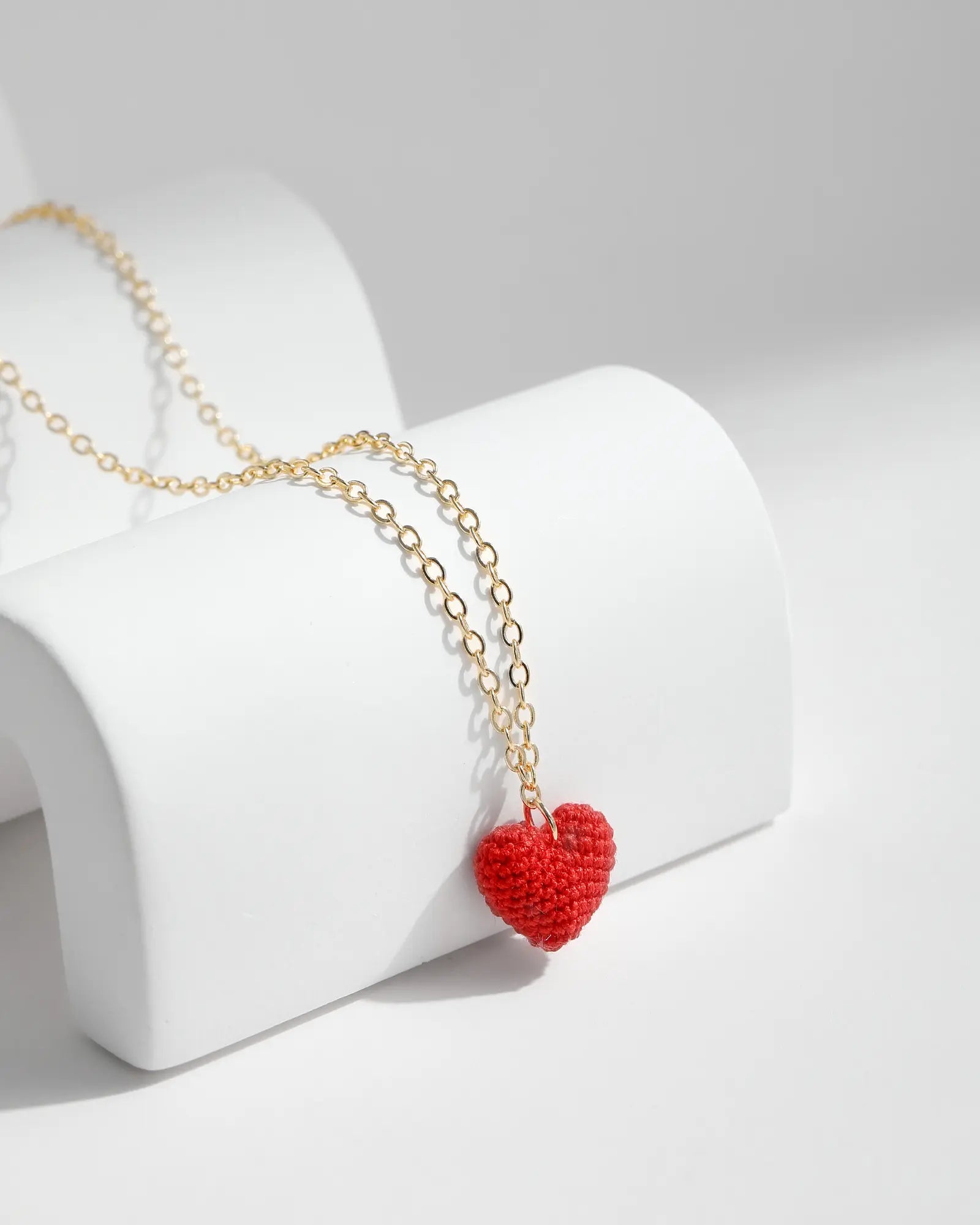 Love Heart Necklace featuring a handmade red micro crochet heart pendant on a delicate gold chain.