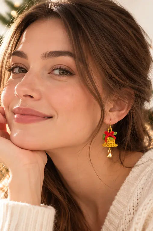 Woman wearing crochet Christmas bell bow earrings