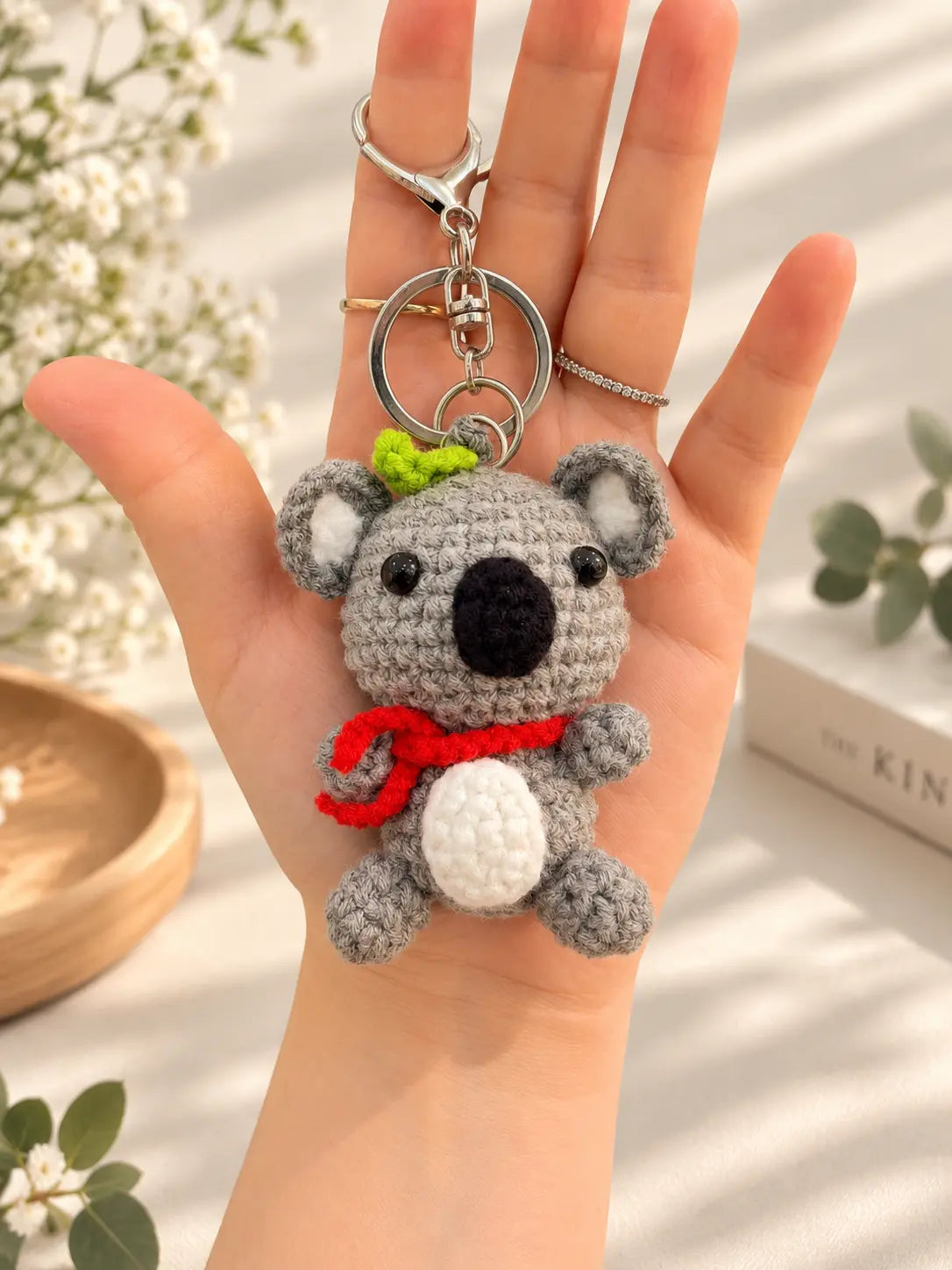 scarf.webp	Handmade crochet koala keychain with a red scarf, shown on a hand with a silver keyring.
