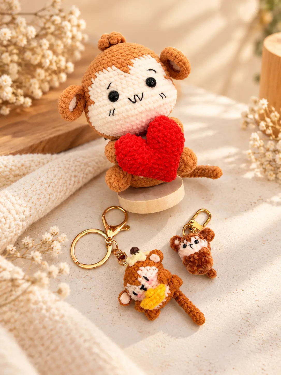 Collection of handmade crochet monkey keychains and bag charms with mini, banana and heart monkey designs
